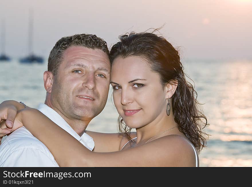 A portrait of attractive couple having fun on the beach. A portrait of attractive couple having fun on the beach.