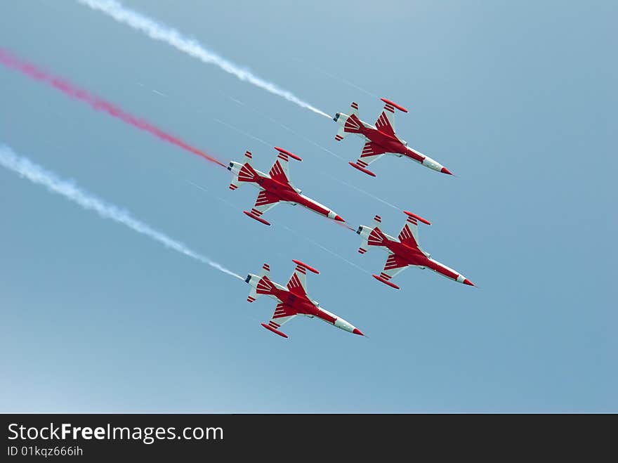 A military air stuntteam in red and white airplanes