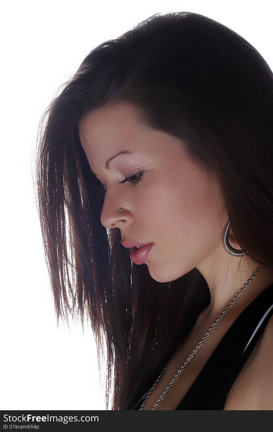 Profile of young brunette girl isolated on white background