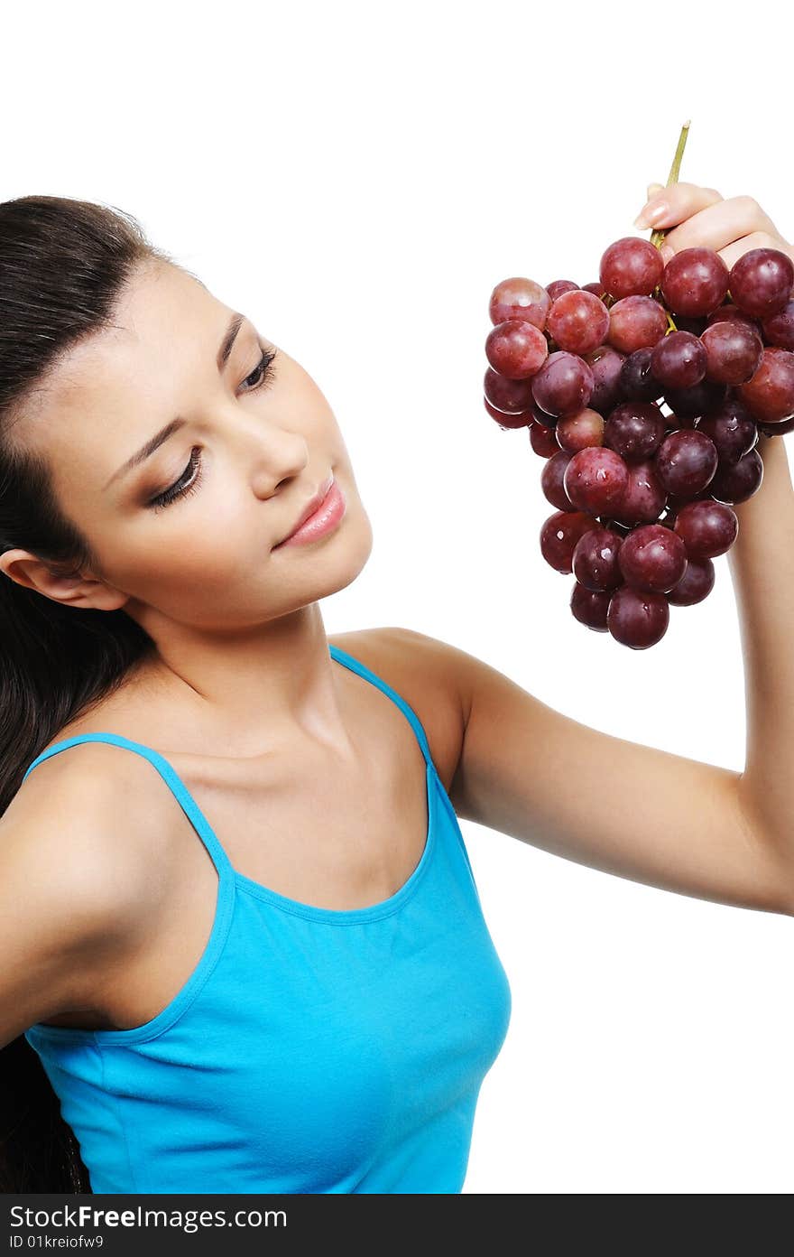 Young attractive woman holding a bunch of grapes - white background