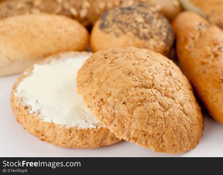 Different types of bread; half of a loaf with butter. Different types of bread; half of a loaf with butter.