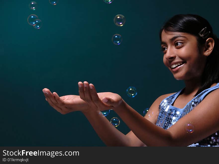 Girl catching lots of bubbles