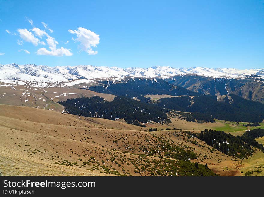 Landscape with snow mountains and clouds