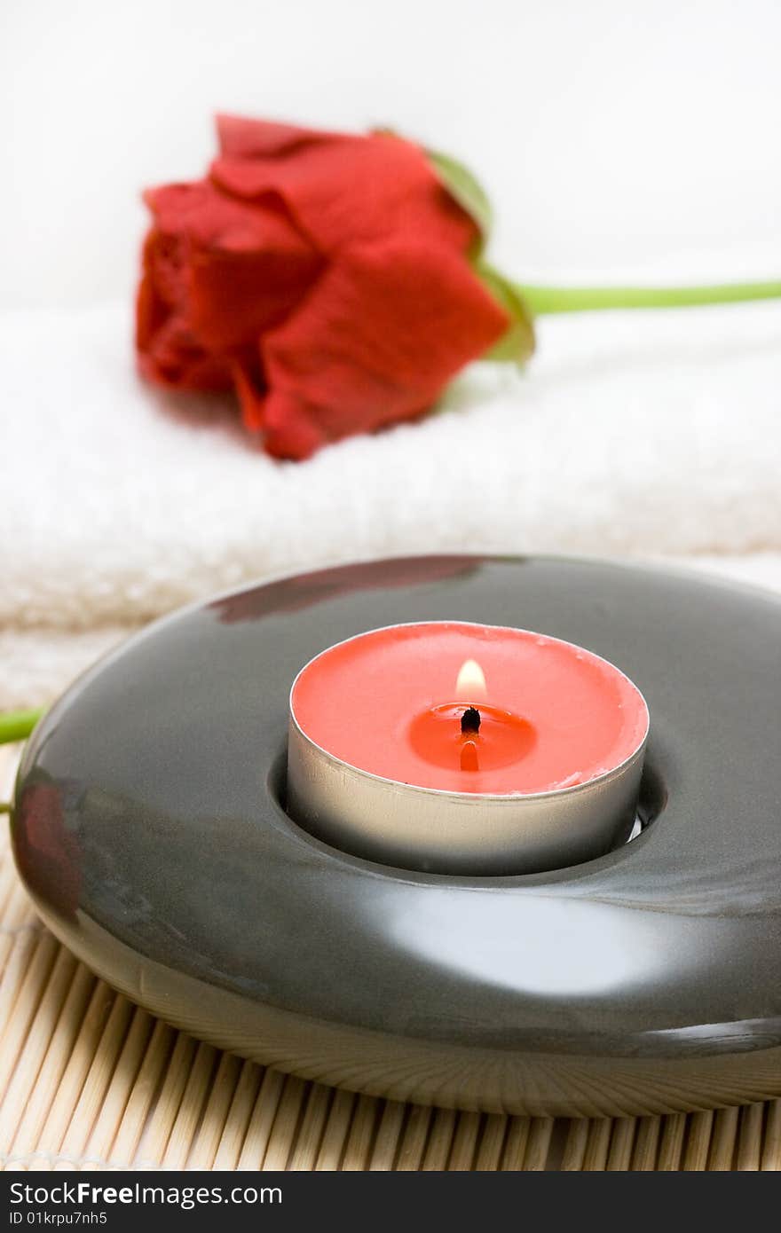 Spa essentials (candle, towel and red rose)