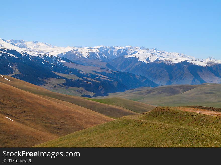 Landscape with snow mountains and the blue sky