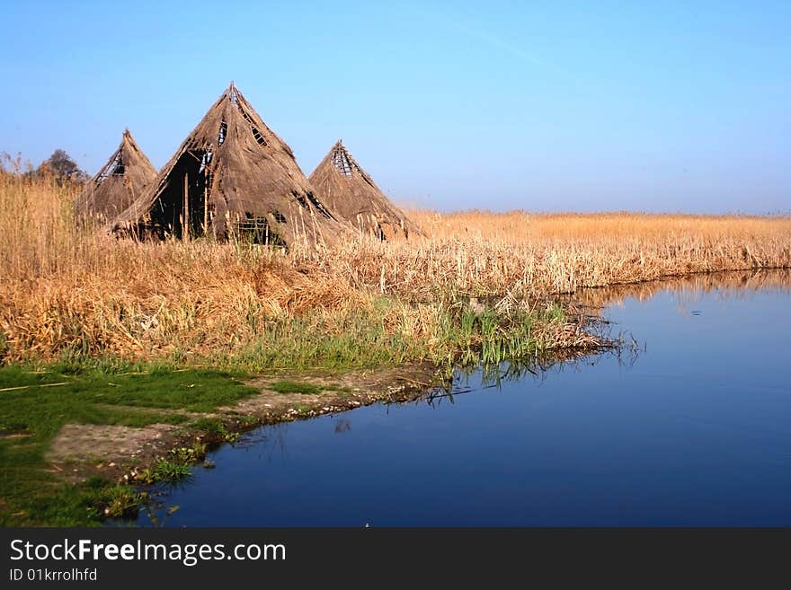 Ancient lacustrian houses forgotten through the reed. Ancient lacustrian houses forgotten through the reed.