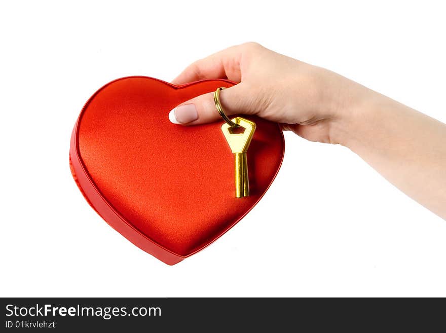 Female hand holding a red box with candy and golden key. Isolated on a white background. Female hand holding a red box with candy and golden key. Isolated on a white background