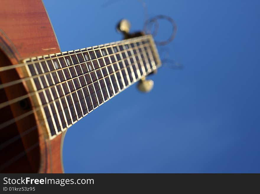 An acoustic guitar and blue sky