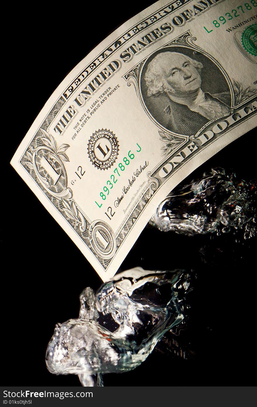 An image of the sinking dollar under water