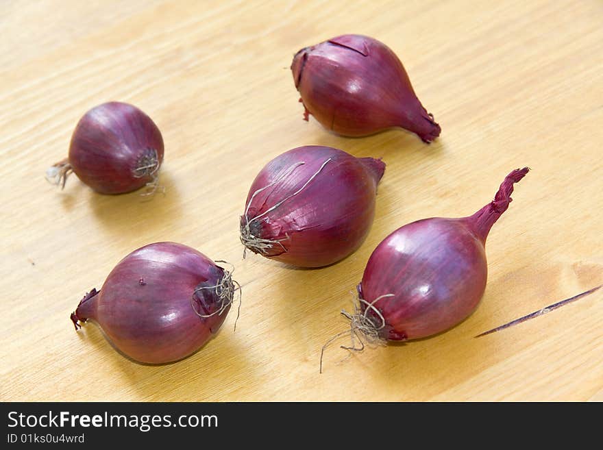 Many Ripe , Red Onions On A Wooden Background