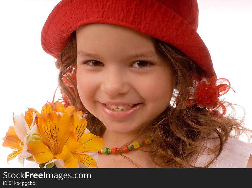 Smiling little girl in a red hat with flowers. Smiling little girl in a red hat with flowers