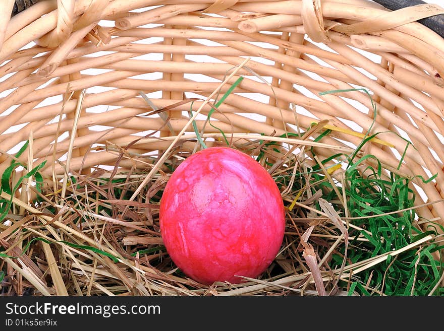 Red Easter egg in a basket