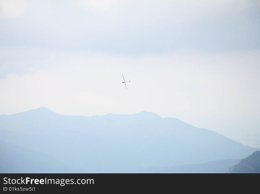 Glider plane flying over Alpine Panorama