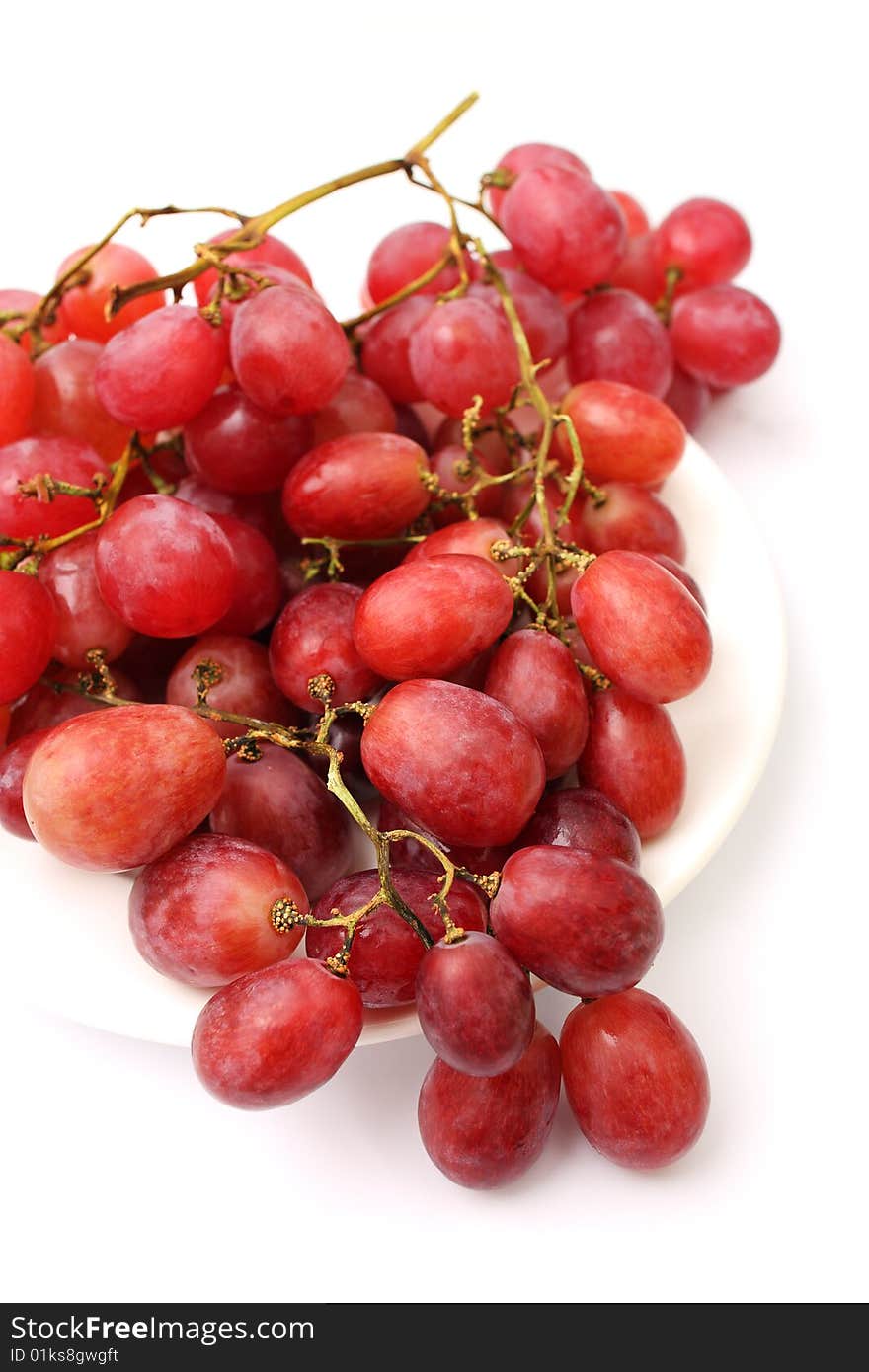 Close up of grapes on plate over white background. Close up of grapes on plate over white background.