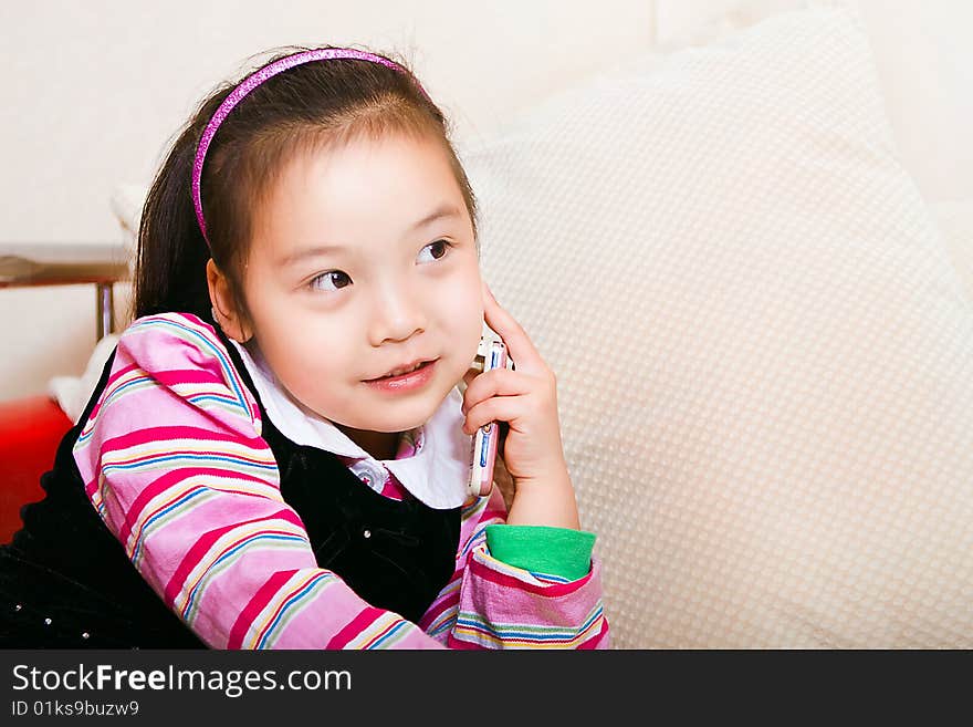 A little girl is called on the phone.