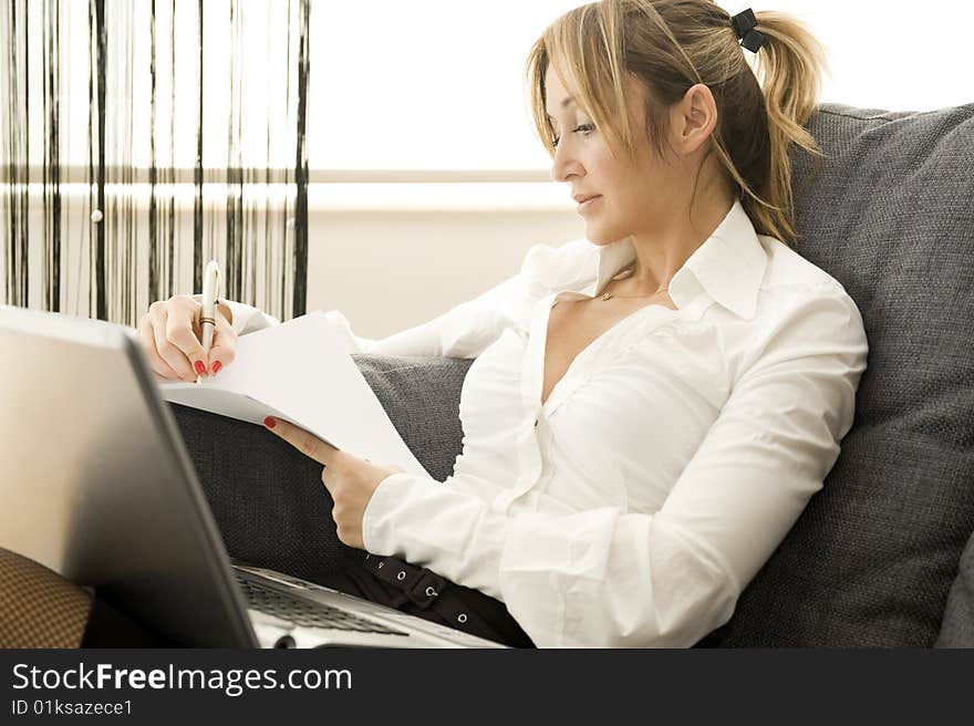 Woman working on her laptop at home. Woman working on her laptop at home