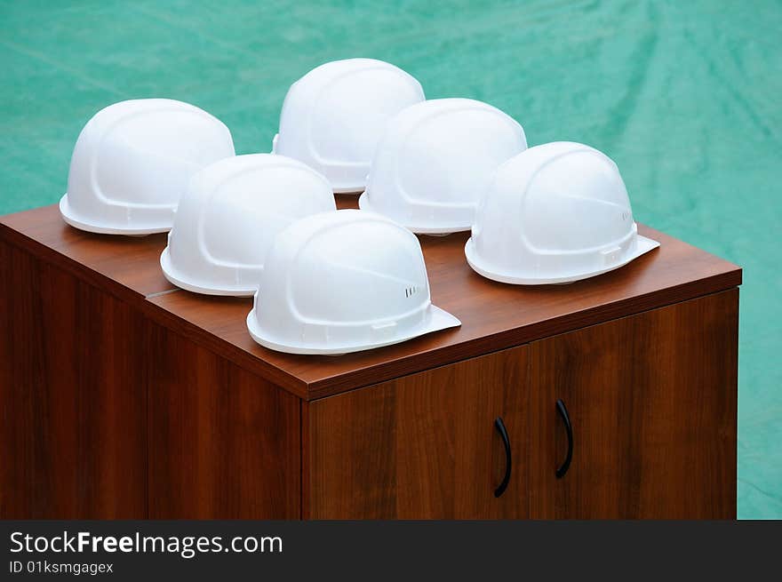 Helmets of builders lie on a bedside table. Helmets of builders lie on a bedside table.