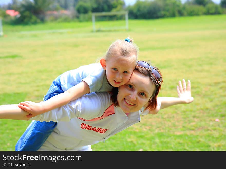 Women and girl playing together. Women and girl playing together