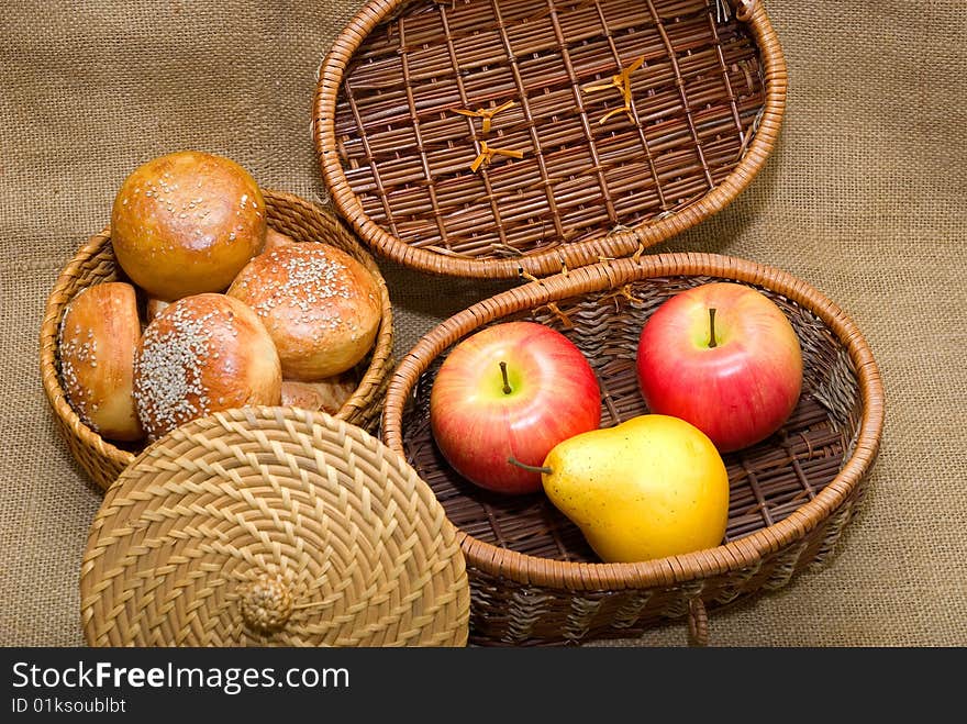 Baskets with rolls and fruits