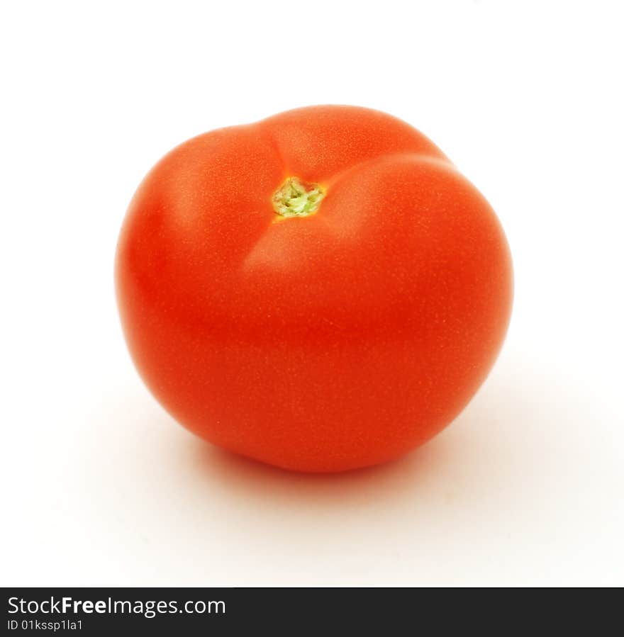 Ripe big red tomato on a white background