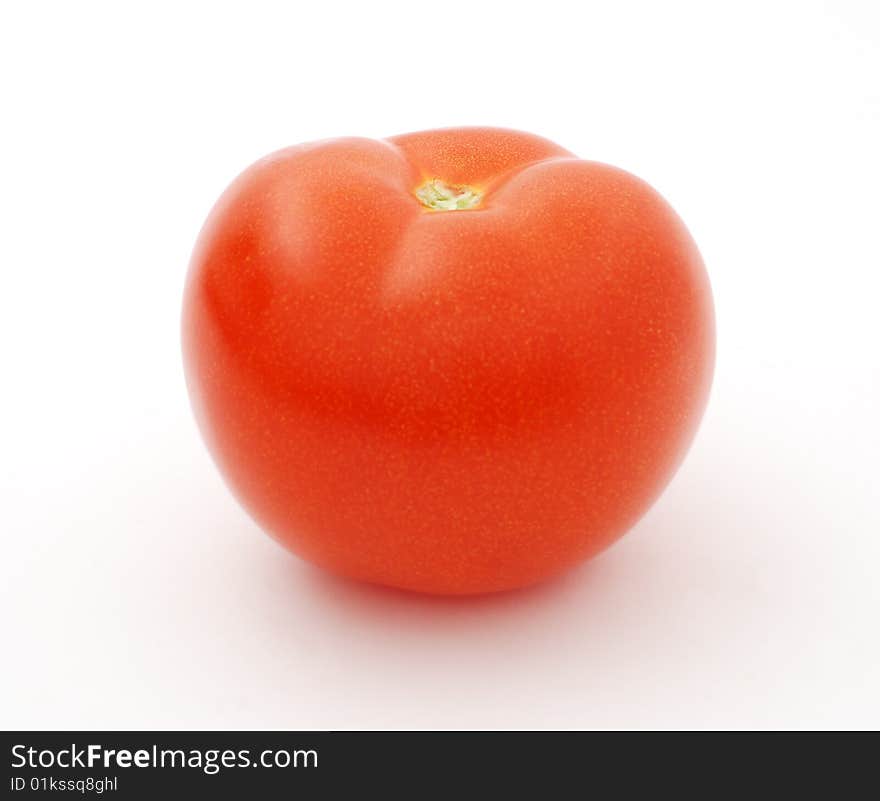 Ripe big red tomato on a white background