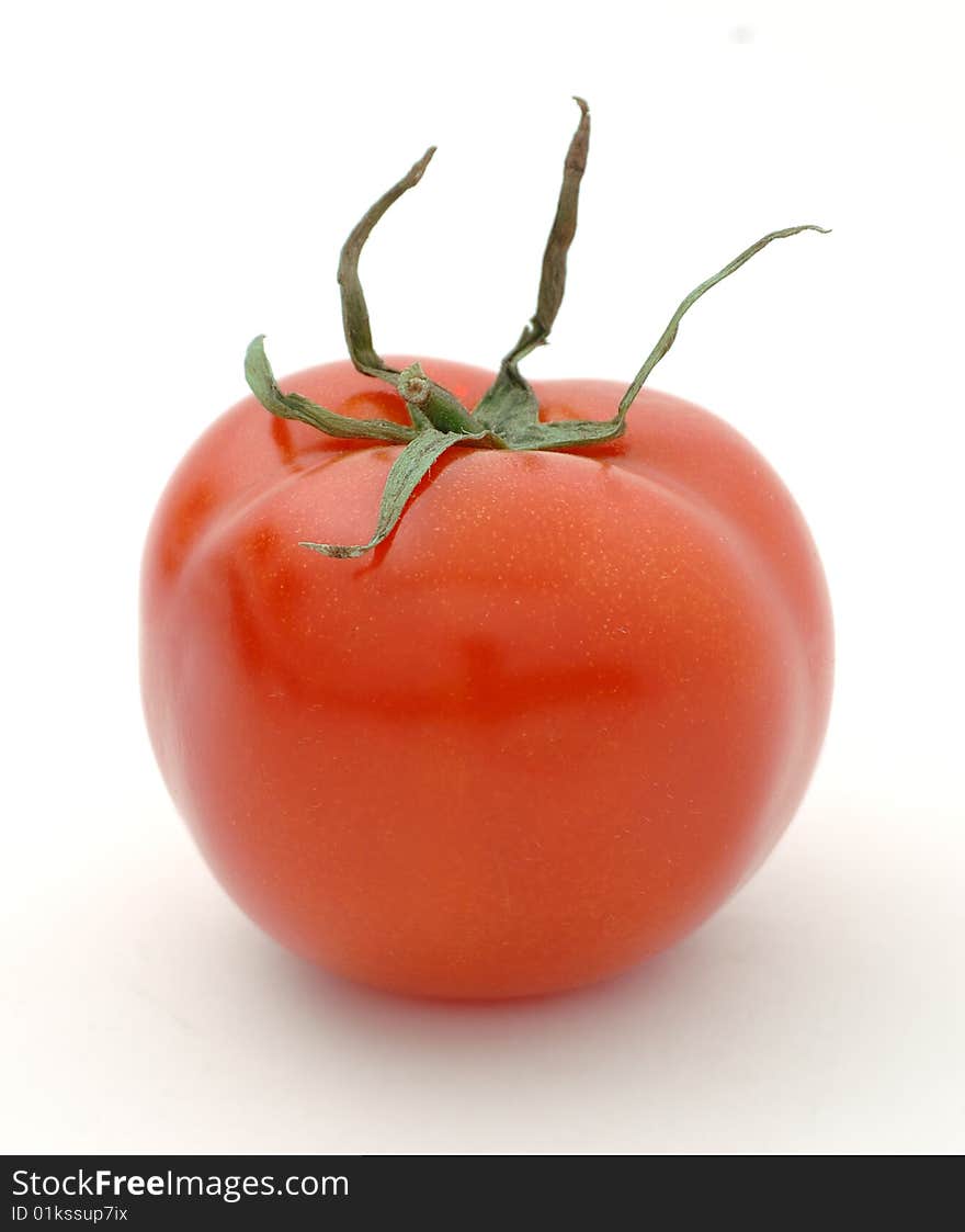 Ripe big red tomato on a white background