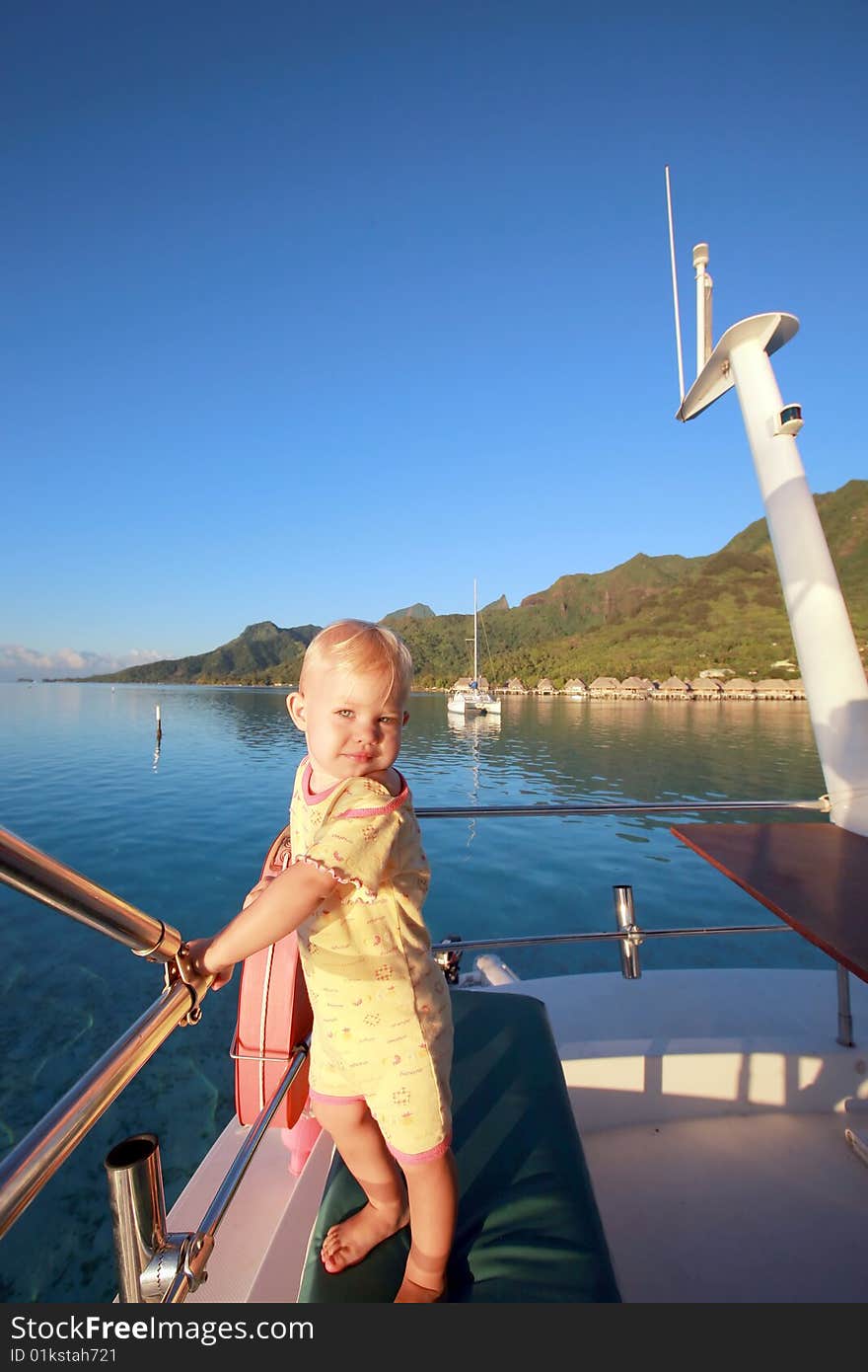 Child on a motor boat at anchor. Child on a motor boat at anchor