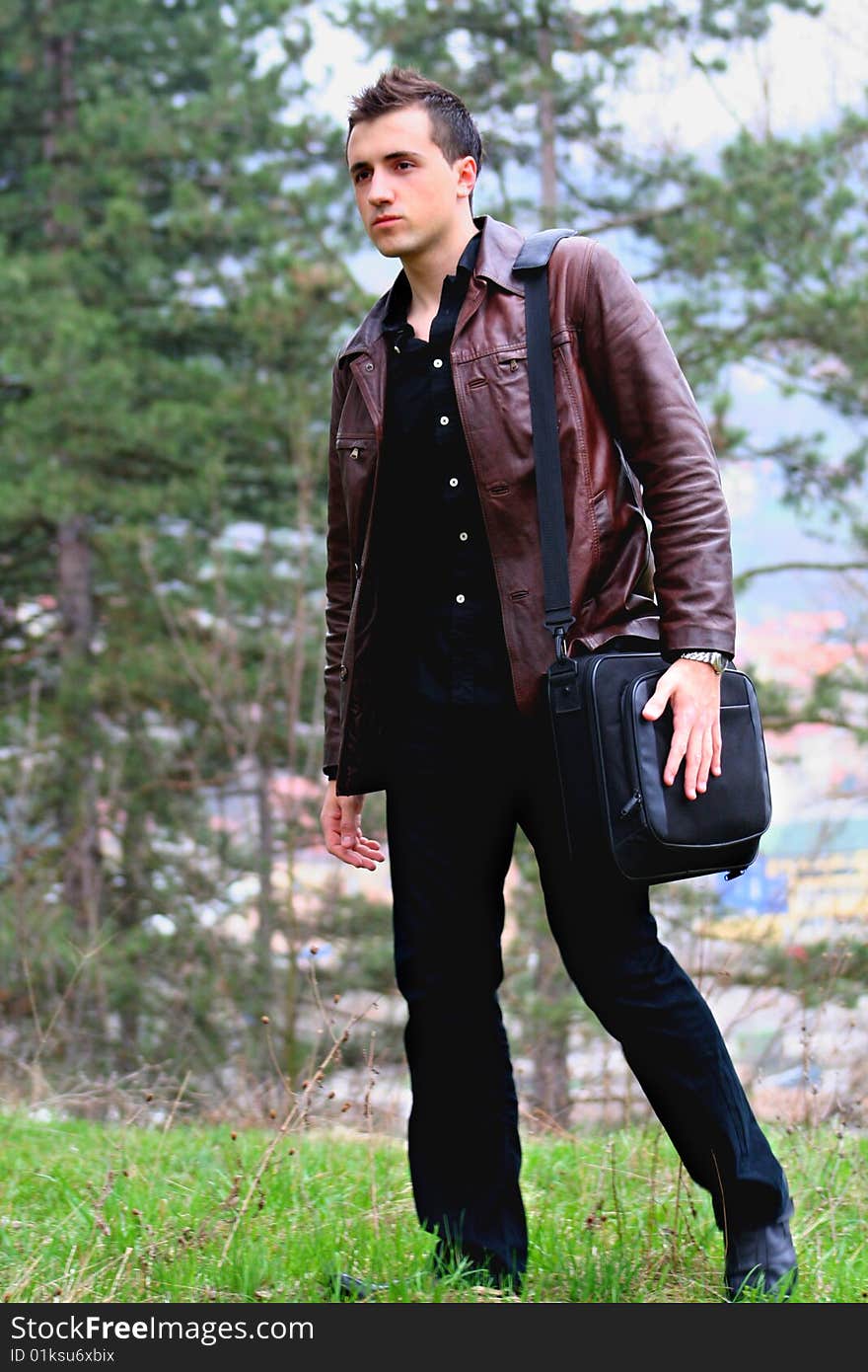 Young Businessman and Briefcase, shot outdoor.