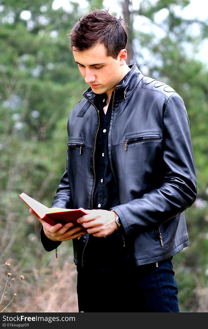 Young Businessman and Notebook, shot outdoor.