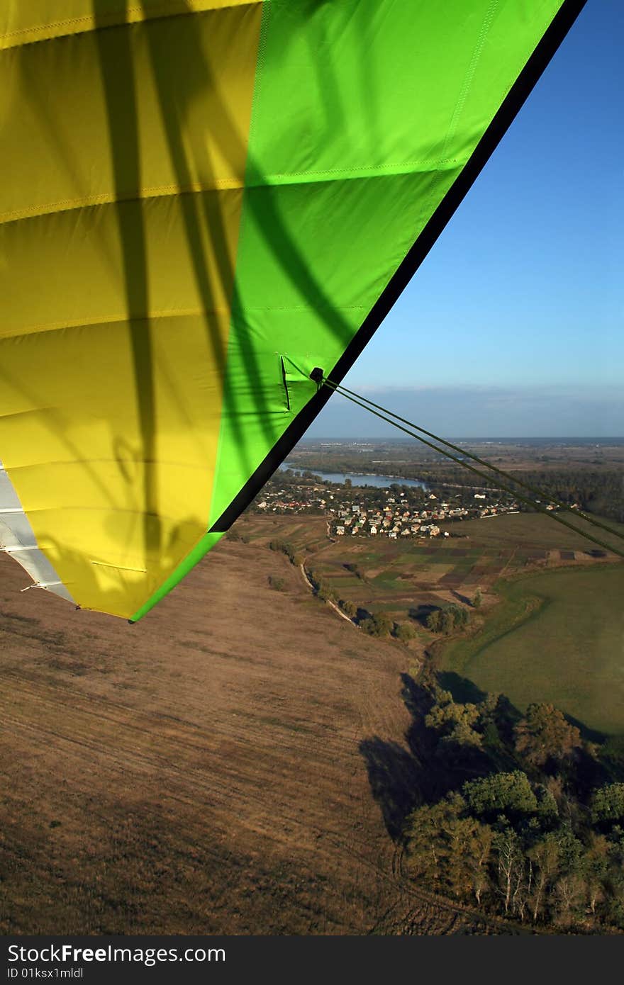 Green and yellow microlight inthe sky. Green and yellow microlight inthe sky