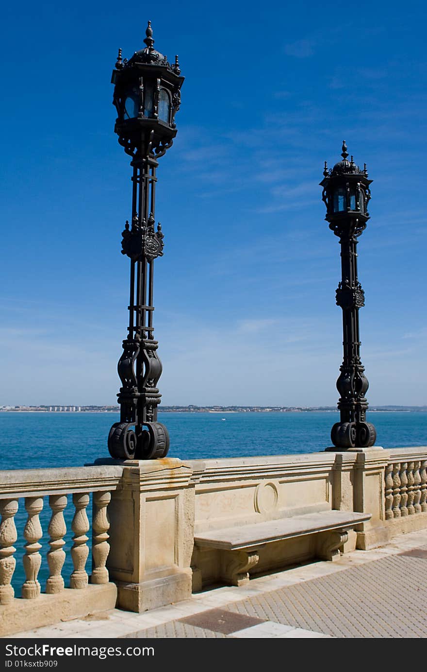 Pair of Wrought Iron lights agaist blue sky