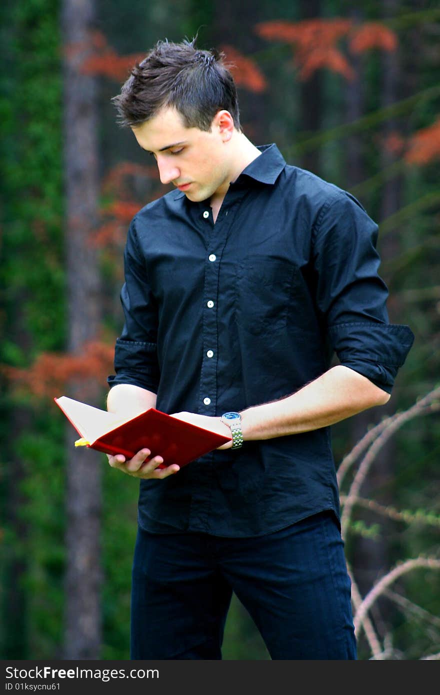 Young Businessman and Notebook, shot outdoors.