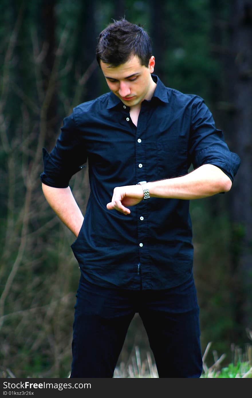 Young Businessman and Watch, shot outdoors.