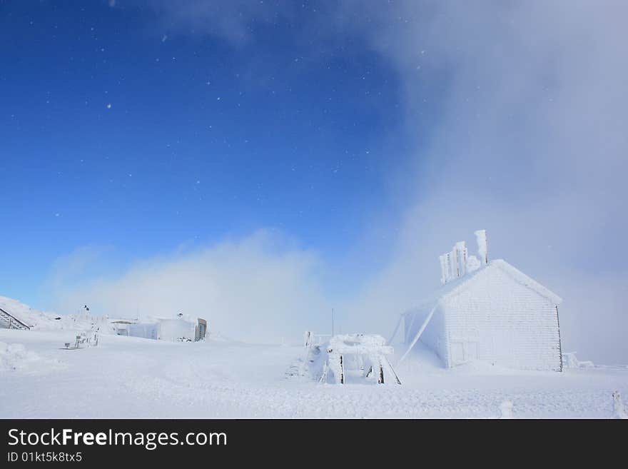 Snow flakes falling in a blue sky without any clouds at Mount Washington. Snow flakes falling in a blue sky without any clouds at Mount Washington