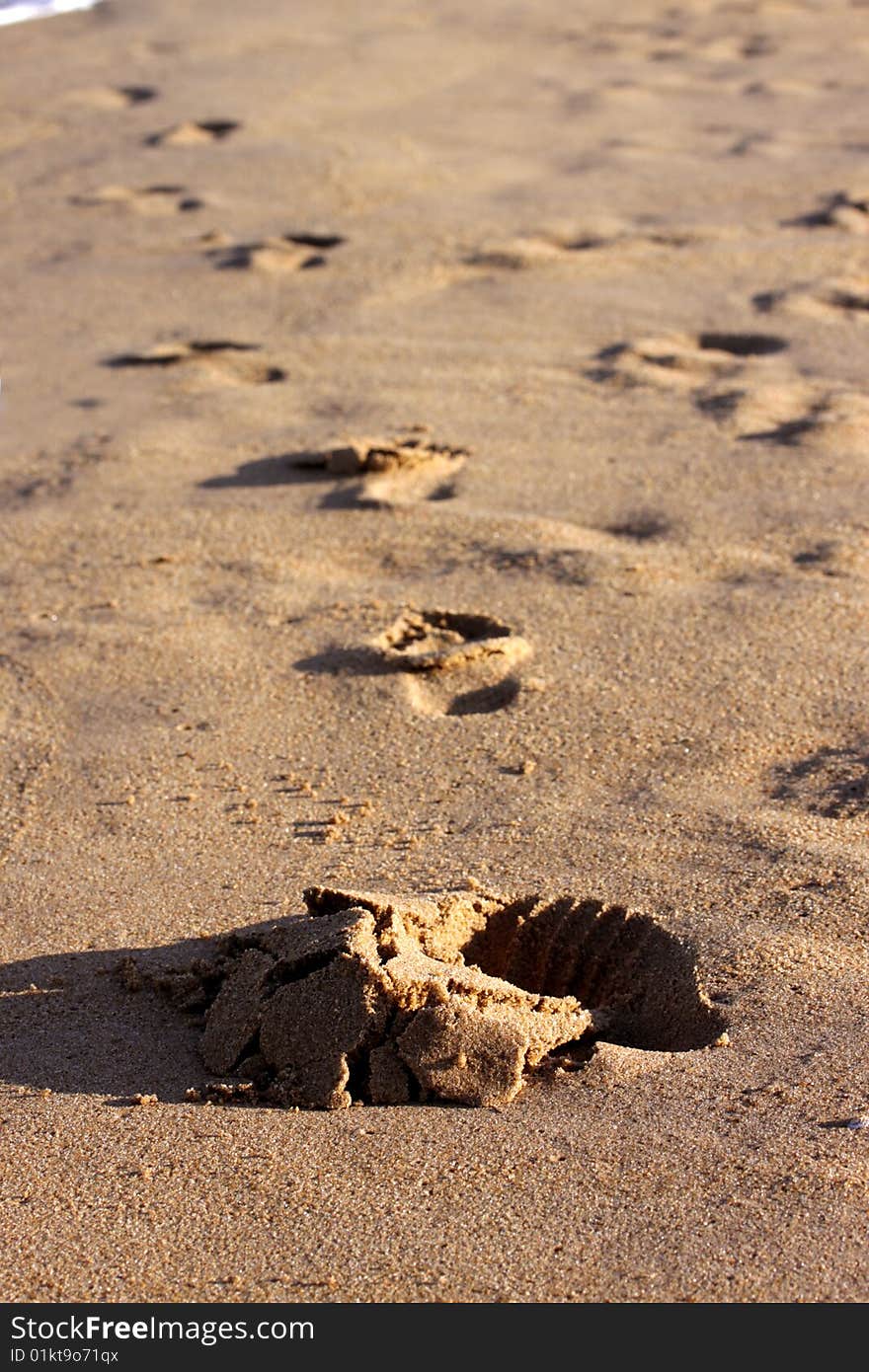 Trace of a foots of the person on sea sand. Trace of a foots of the person on sea sand