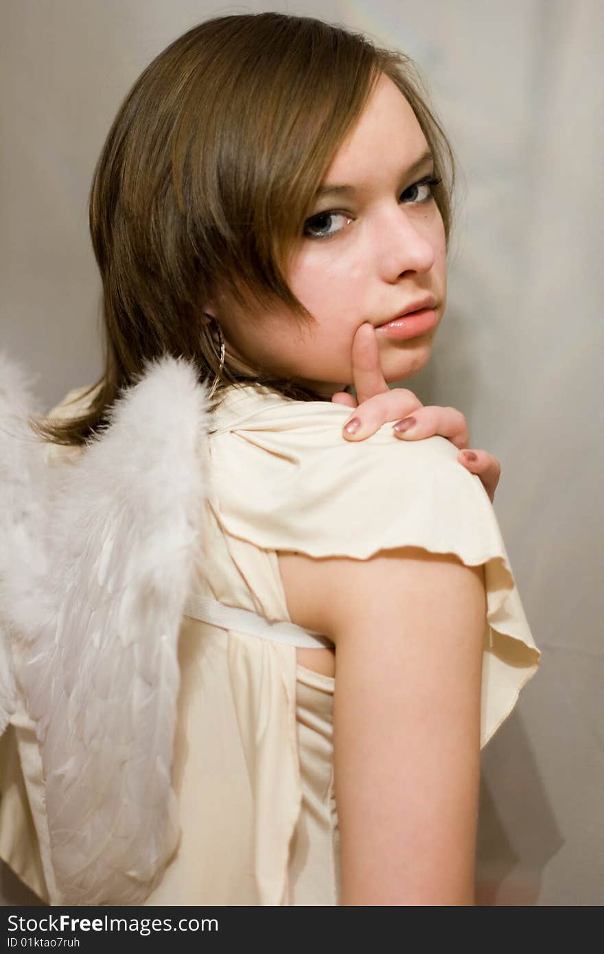 Beautiful girl with white wings behind their backs. Beautiful girl with white wings behind their backs