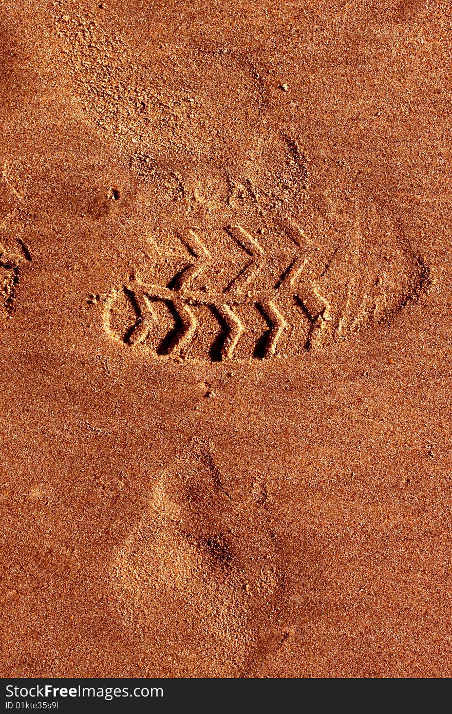 Trace of a foot of the person on sea sand. Trace of a foot of the person on sea sand