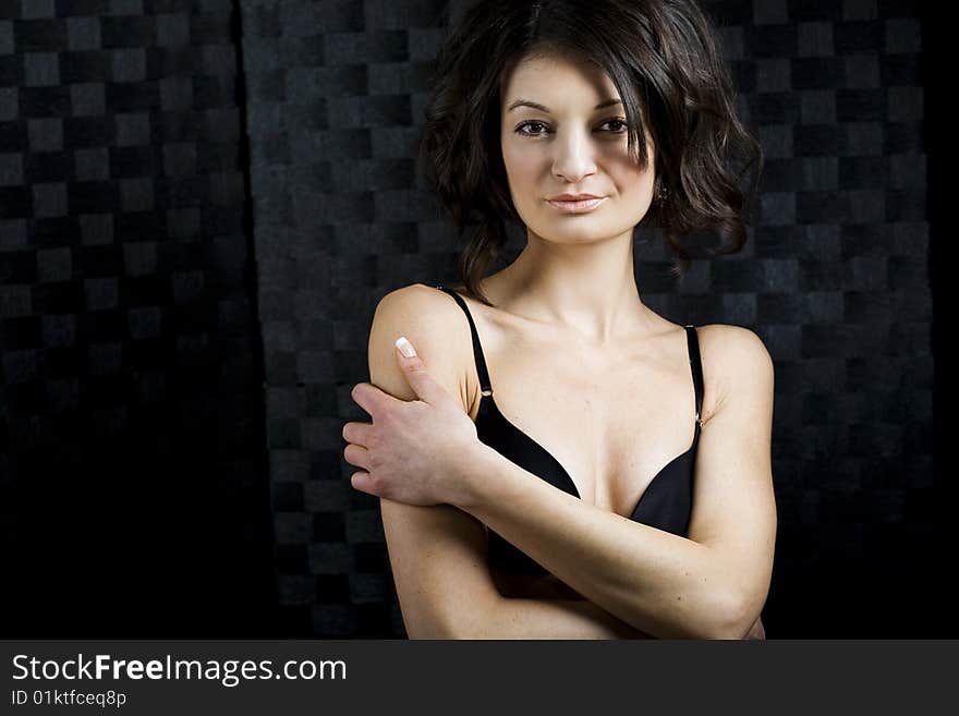 Twenty-something woman poses in bra in this elegant portrait. Twenty-something woman poses in bra in this elegant portrait.