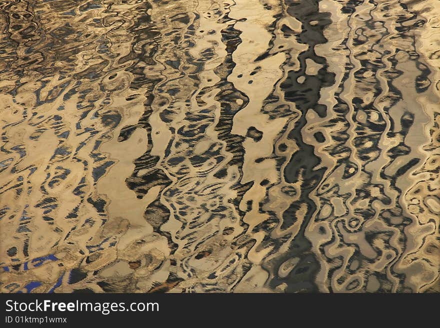 Reflection of a multistory building from a surface of the river.