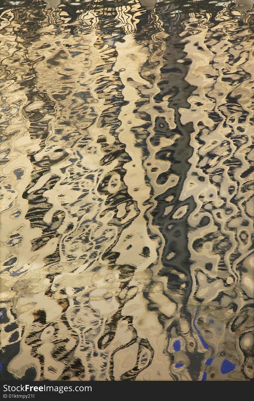 Reflection of a multistory building from a surface of the river.