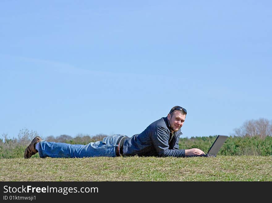 Man on meadow with laptop. Man on meadow with laptop