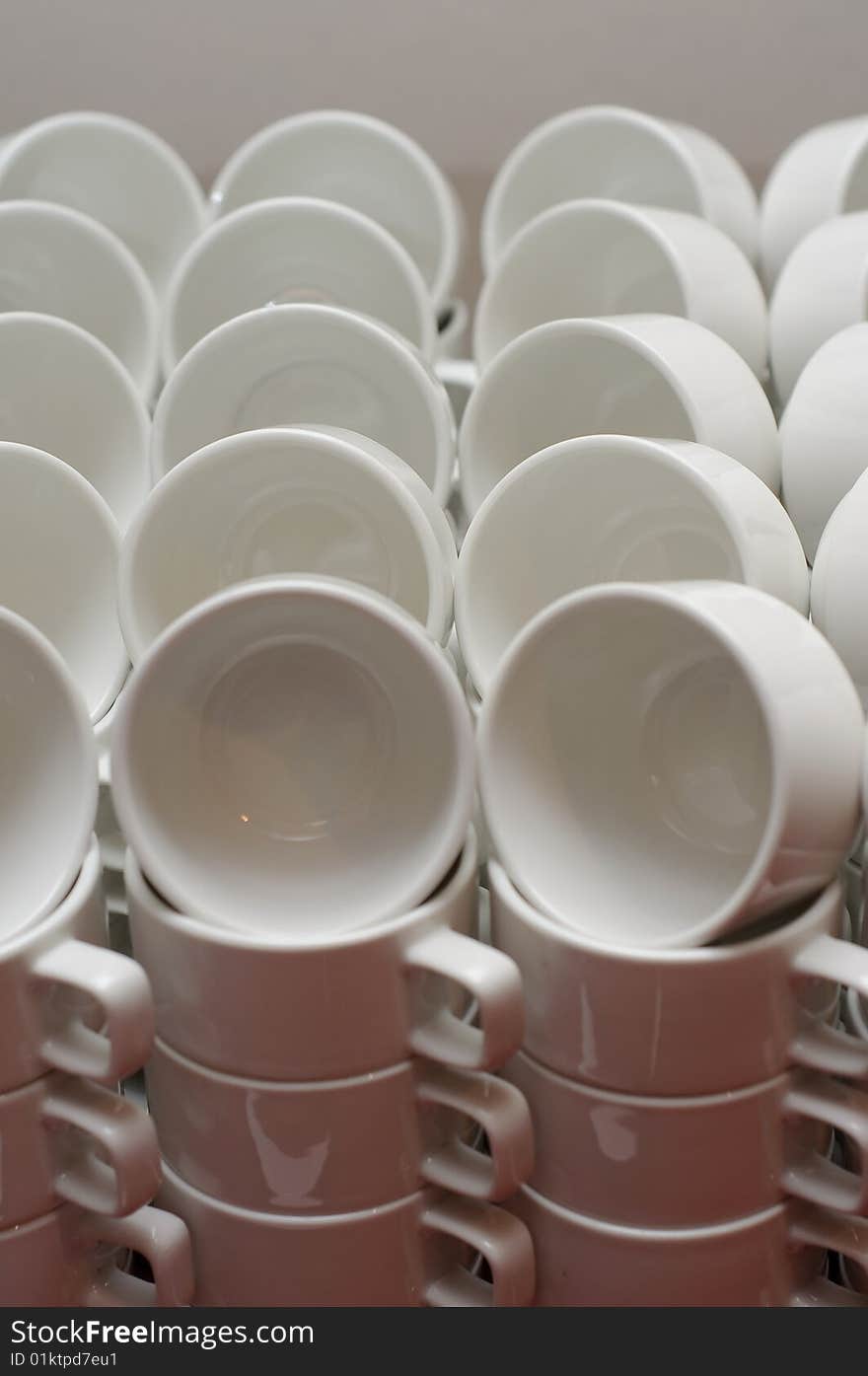 Neatly arranged white coffee cups