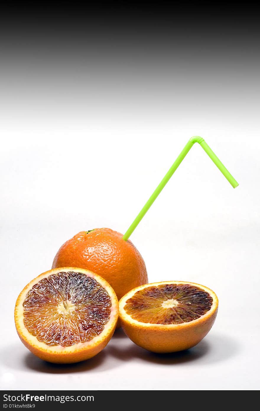 Orange with straw on a white background