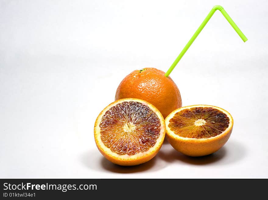 Orange with straw on a white background