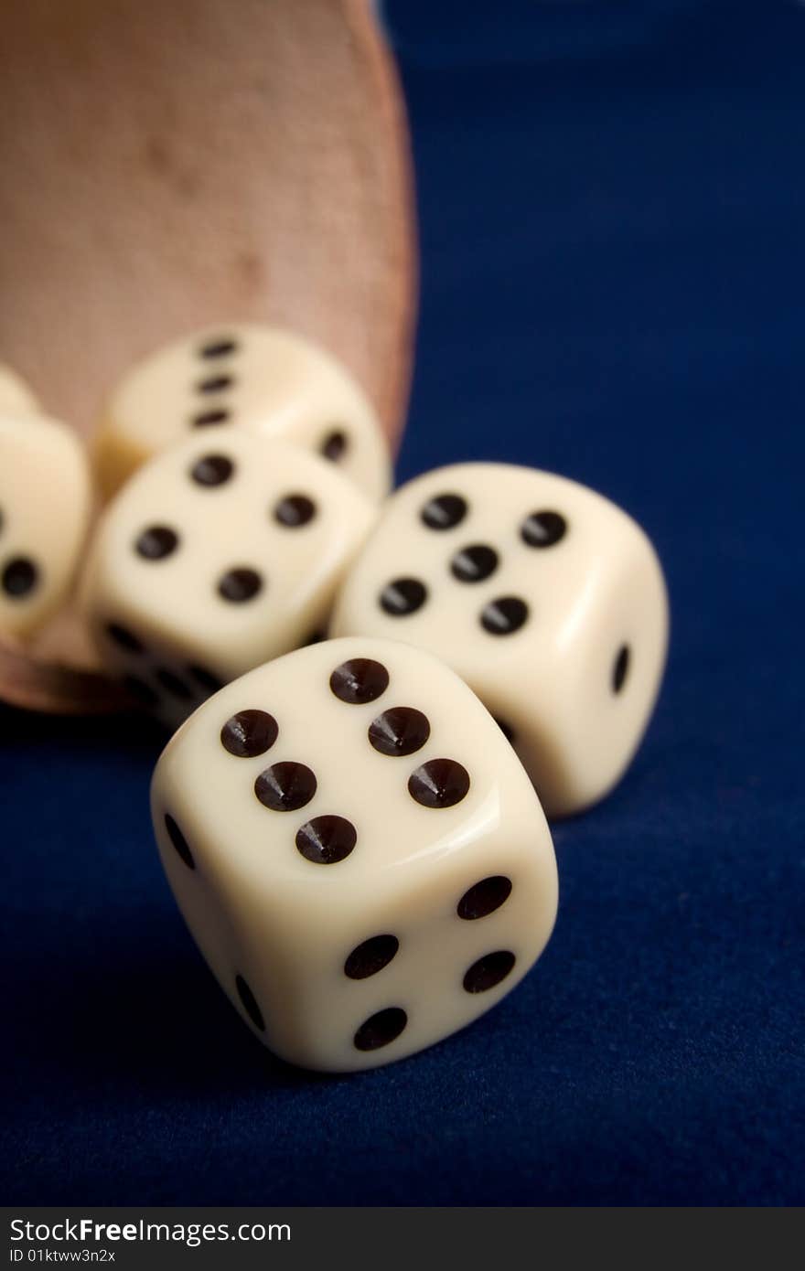 Dice cup and dice on background