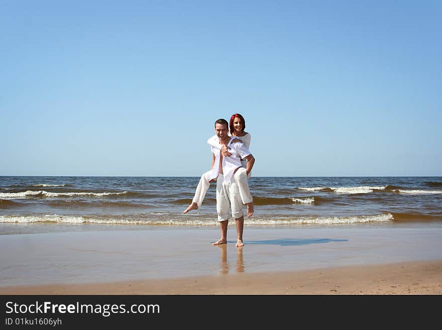 Beautiful yound couple relaxing on the beach. Beautiful yound couple relaxing on the beach