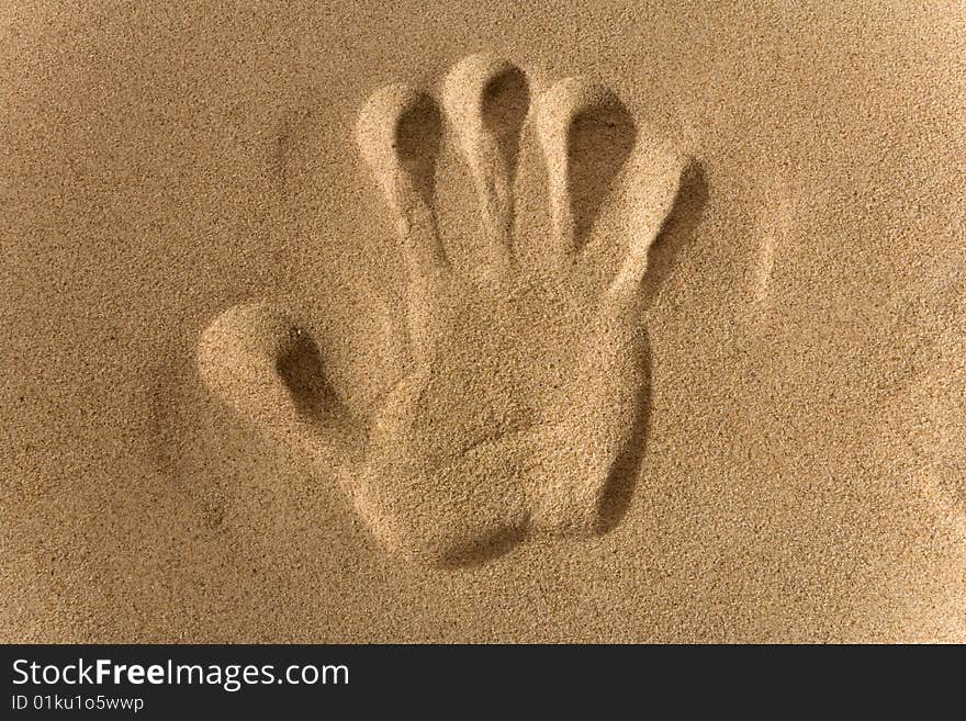 Close-up of hand imprints in sand