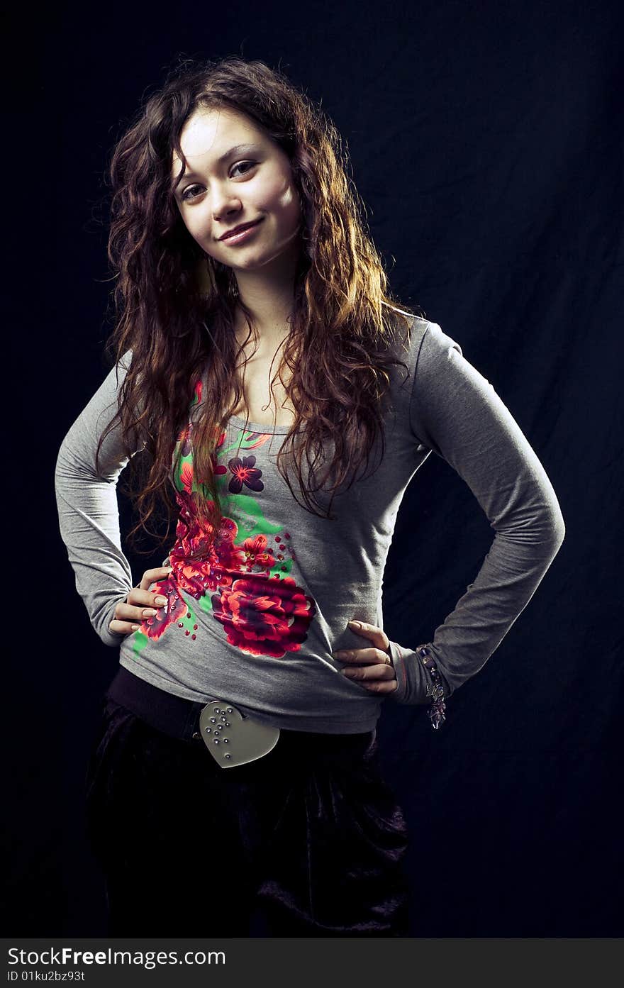 Portrait of a young dark-haired girl in the black background. Portrait of a young dark-haired girl in the black background