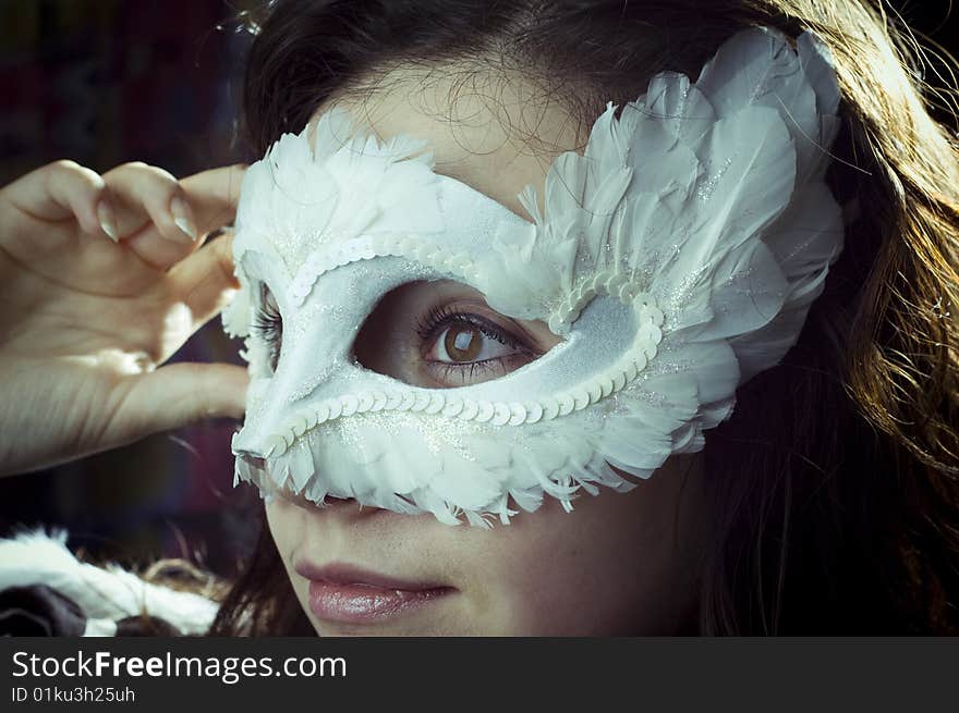 Studio portrait of a girl in a mask