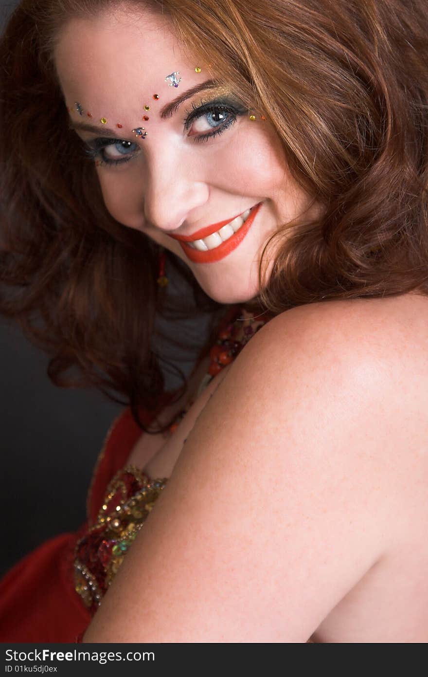 Belly Dancer wearing a red costume with jewelery. Belly Dancer wearing a red costume with jewelery